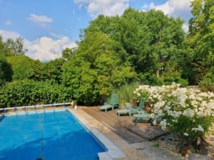 an outdoor swimming pool with a decked area and long chairs needs a lot of planning