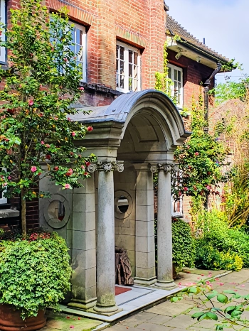 A period house with a stone porch and flowers in Highgate London N6